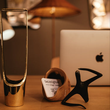 Gold vase on a wooden surface with blurred background