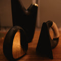 aubock bookends and aorta vase on wood desk