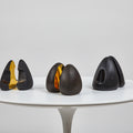 Set brass bookends on a white pedestal against a light gray background