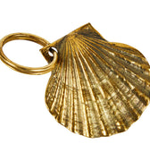 Gold scallop shell keychain on a white background