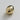Gold spherical object on a light gray background