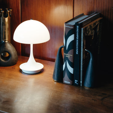White table lamp on a wooden surface with decorative items