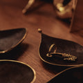 patinated trio of auböck dishes on a wooden surface