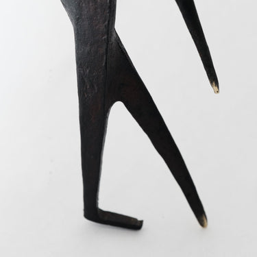 Black abstract sculpture on a white background