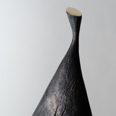 Abstract black sculpture on a gray background