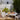 Hans-Agne Jakobsson painted Metal  'Rulle' Outdoor Sconce for Orsjo black painted on a lush patio setting