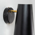 Black wall-mounted lamp with gold accent on a white background