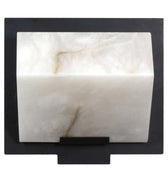 Decorative wall sconce with alabaster finish and black frame on a white background