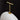 Close-up of a white lampshade with a gold fixture on a black background