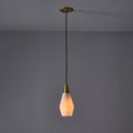 Pendant light with a gold fixture and white shade on a gray background