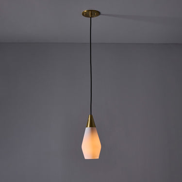 Pendant light with a gold fixture and white shade on a gray background