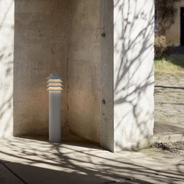 Bysted Garden Bollard Louis Poulsen Lifestyle photograph against concrete wall pathway light