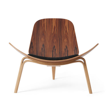 hans wegner shell chair with a black cushion on a white background