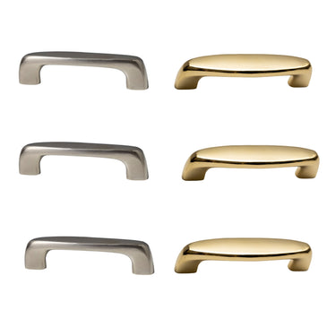 Set of six metallic cabinet handles in brass and nickel on a white background