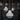Modern pendant lights hanging above a bar with dark cabinets and beer taps.