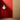 White cirque pendant light hanging against a red wall with a wooden floor and curtain. 'Cirque' Pendant Lamp by Clara von Zweigbergk for Louis Poulsen Two enlighten