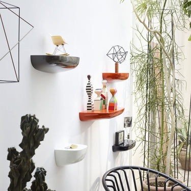 Modern interior with wall shelves, decorative items, and a chair.