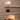 Two spherical lamps on shelves with a warm glow against a beige wall.