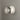white fresnel oluce light fixture on a gray wall