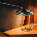 tynell 5321 gubi lamp on warm wood table