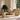 Wicker chaise longue chair in a room with large windows and a plant