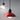 Red pendant light with a black base on a gray background