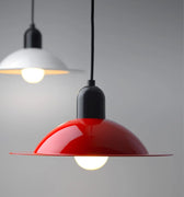 Red pendant light with a black base on a gray background