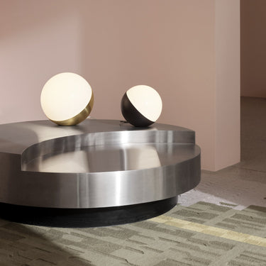 Modern coffee table with two spherical lamps on a neutral background