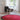 large round aros rug with miguel mila lamp and gio ponti chair in white room