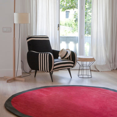 large round aros rug with miguel mila lamp and gio ponti chair in white room