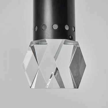 Close-up of a geometric crystal pendant light on a gray background
