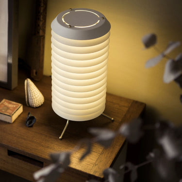 Table lamp with ribbed design on a wooden surface
