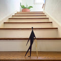 man with stick on staircase
