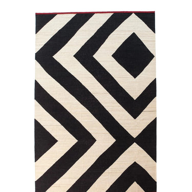 Rug with black and beige geometric  diamond pattern on a white background