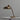 Bronze brass lariolux desk lamp on a white surface with a gray background