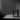 Wooden table against a dark gray wall with a spotlight effect
