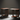 Two wooden side tables on a dark background