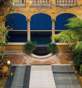 Ornate courtyard with arches, pool, and greenery