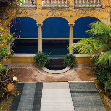 Ornate courtyard with arches, pool, and greenery