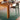 Wooden dining table with a typewriter and decorative items, jean prouve standard chair set on a green rug.