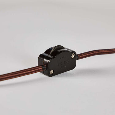 cord switch with brown cable on a light gray background