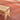 Wooden bench on a textured red and brown rug