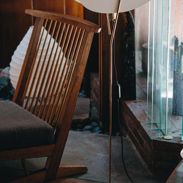 nun floor lamp in wooden house with nakashima chair