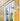 White danish outdoor wall light fixture on a yellow building exterior.