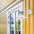 White danish outdoor wall light fixture on a yellow building exterior.