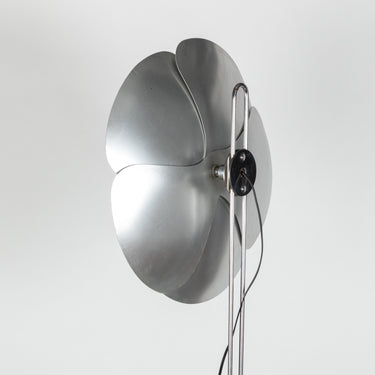 Modern floor lamp with metallic design on a white background