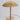 Gold table lamp with pleated shade on a light gray background