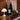 christmas decor midcentury inspo with wine bottle on a wooden surface with decorative items and a lamp.