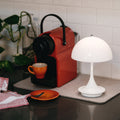 two-enlighten-portable-lamps-panthella 160 opal white on a kitchen counter
