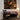 Living room with a painting on the wall, a rocking chair, and a lamp.
